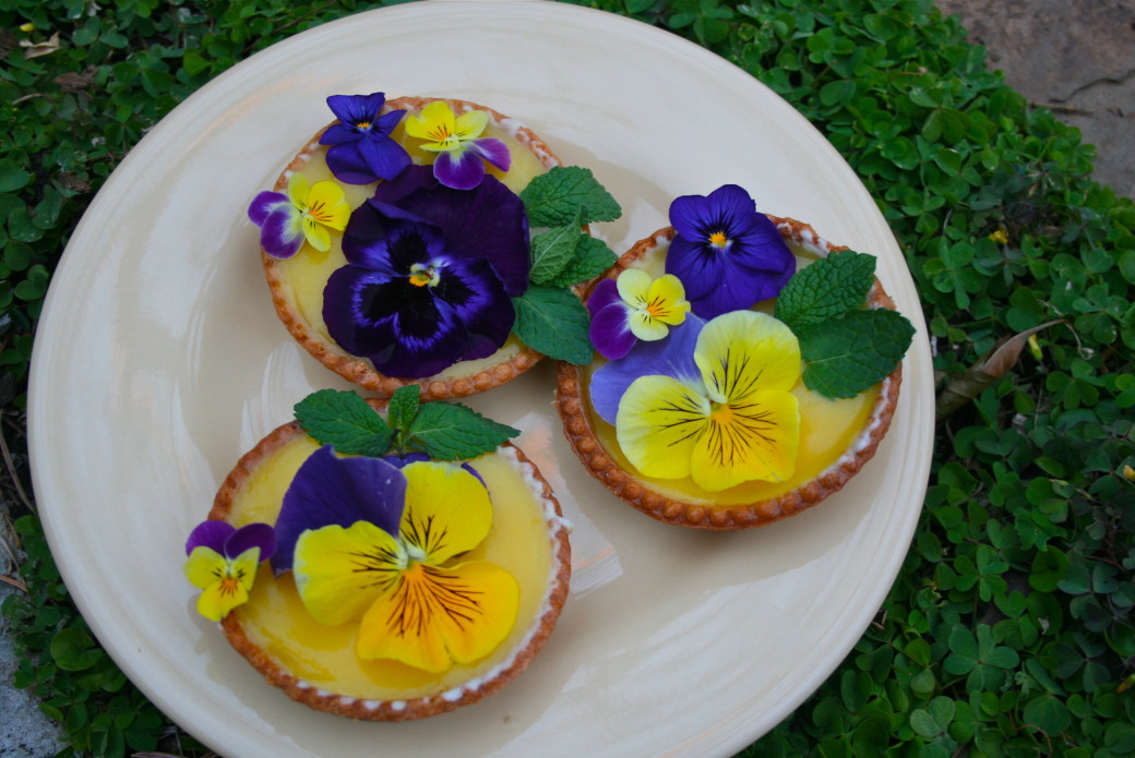 lemon tart garnished with edible flowers